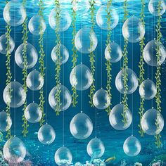 an underwater scene with bubbles and plants hanging from strings