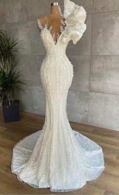 a white wedding dress on a mannequin