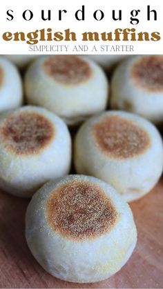 several english muffins on a wooden surface with text overlay that reads sourdough english muffins simplily and a starter