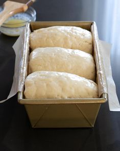 three loaves of bread sitting in a pan