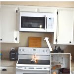 a white stove top oven sitting inside of a kitchen next to a microwave and cabinets