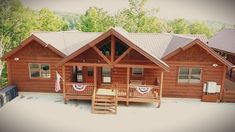 a wooden cabin with porches and rocking chairs