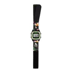 a black and green watch with flowers on the front, sitting against a white background