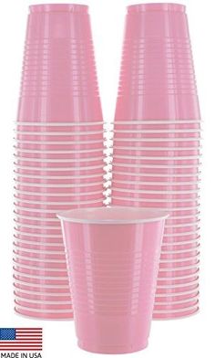 pink plastic cups are stacked on top of each other