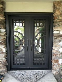 a black double door with two sidelights and glass panels on the front entrance to a home