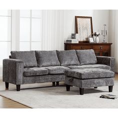 a living room with a sectional couch and ottoman