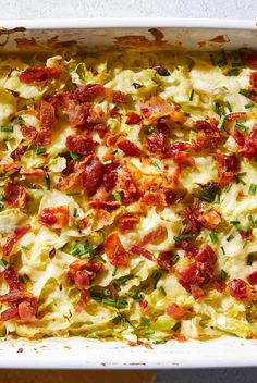 a casserole dish with bacon, cheese and other toppings in a baking pan