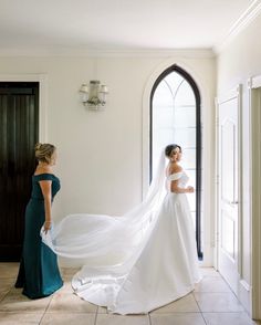 the bride is getting ready to walk down the aisle with her veil blowing in the wind