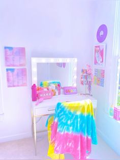 a bedroom with a tie dye blanket on the bed and a mirror in the corner