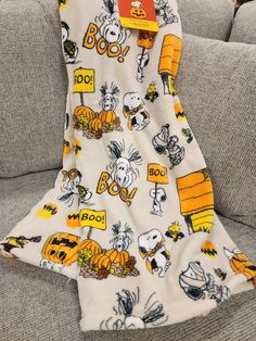 a blanket that is sitting on top of a couch with snoop the dog and other cartoon characters