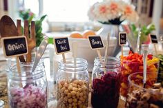 a table topped with jars filled with different types of candies