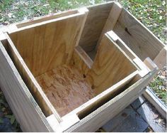 an unfinished wooden box sitting on the ground