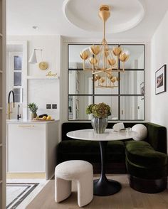 a living room filled with furniture and a chandelier hanging over it's head