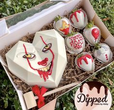 a box filled with cupcakes decorated to look like the face of a clown