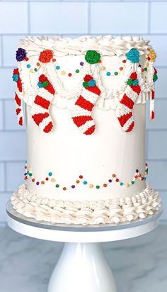 a white cake decorated with candy canes and candies