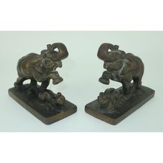 two bronze figurines depicting elephants playing with each other