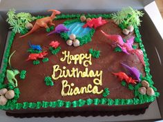 a birthday cake with dinosaur decorations on it