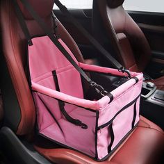 a car seat with a pink dog carrier in the passenger's side area,