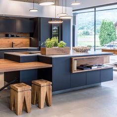 a kitchen with an island and wooden stools