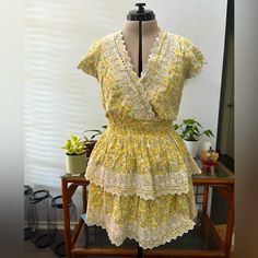 Yellow Floral Pattern With White Lace Edging, Smocked Waist, Cotton/Linen Blend Material Yellow Knee-length Dress With Ruffle Hem, Casual Yellow V-neck Floral Dress, Yellow Floral Print Knee-length Dress, Yellow V-neck Sundress With Ruffles, Yellow Floral V-neck Sundress, Floral Ruffle Dress, Floral Ruffle, Lace Edging, Yellow Floral