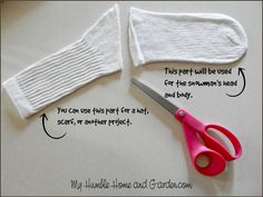 a pair of pink scissors sitting on top of a table next to a white glove