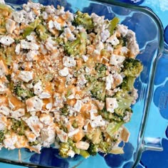 broccoli cheddar bake in a glass dish on a blue background