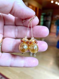 Another pair by perfectionist Laura Maddams Bentley.  These are perfect to ring in the New Year.  Golden, classy orb combo just the right size.  14k gold filled earwire. Elegant Round Glass Earrings, Formal Gold Glass Earrings, Elegant Yellow Gold Glass Jewelry, Czech Glass Round Jewelry Gift, Elegant Glass Jewelry With Wire Wrapping, Round Czech Glass Jewelry Gift, Elegant Hypoallergenic Glass Jewelry, Czech Glass Round Jewelry For Wedding, Handmade Elegant Spherical Jewelry