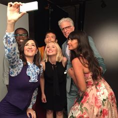 a group of people taking a selfie in front of a camera with one person holding up a cell phone