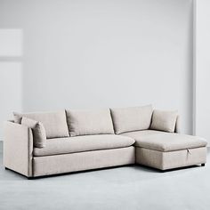 a white couch sitting on top of a gray floor