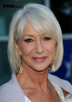 an older woman with blonde hair smiling at the camera and wearing earrings on her head