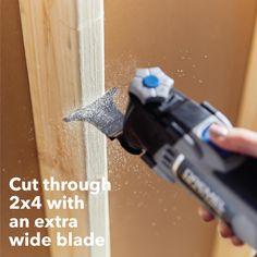 a person using a drill to cut through the wall with an extra wide blade