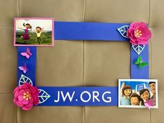 a blue frame with pink flowers and pictures on it that says jw org