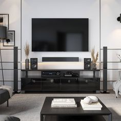 a living room with a large flat screen tv mounted on the wall above it's entertainment center