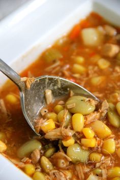 a spoon full of soup with beans and meat