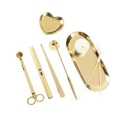 a set of golden items including scissors, combs and candles on a white background