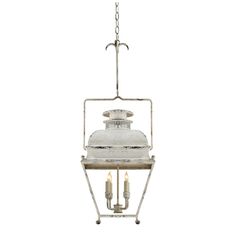 an old fashioned hanging light fixture with three candles