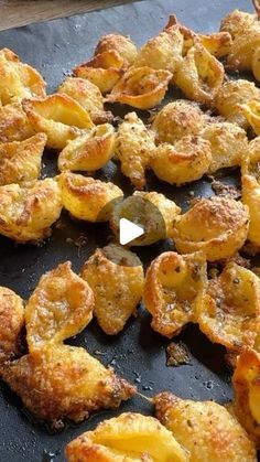 some fried food is laying out on a pan and ready to be cooked in the oven