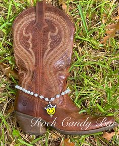 Our Cowboy Boot Charms are super cute. We think you only need one Cowboy Boot Charm to style up one boot but if you would like two, please do :) Simple, fun, cute and trendy Cow Print Smiley Cowboy Boot decor; handmade to perfectly hang on your boot. You can let your charm dangle at the side or back of your boot - whatever makes the Cowgirl happy :) Everybody loves a smiling cowboy sporting a cute cow print cowboy hat :)  With this listing, you will receive one smiley pearl boot charm necklace :) We also make this cute cow print cowboy as a pearl choker necklace for humans instead of boots as well :)  Please check out our other listing for our pearl necklace :) Show us some Texas love <3 Thanks for shopping fun, affordable, handmade gifts @ Rock Candy Bar! Boot Jewelry Custom, Boot Decor, Pearl Boots, Boot Charms, Boot Charm, Cowboy Love, Pearl Charm Necklace, Boot Bracelet, Texas Gifts