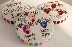 three decorated christmas cookies sitting on top of a table