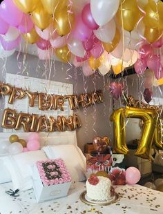 a birthday party with balloons, cake and decorations