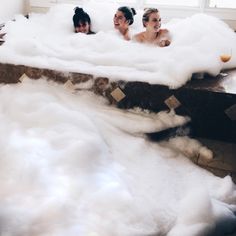 two women in a foam bath with bubbles