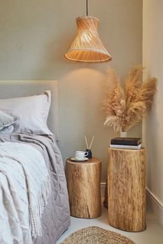 a bed room with a neatly made bed and two nightstands next to each other