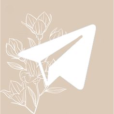 a white paper airplane sitting on top of a plant