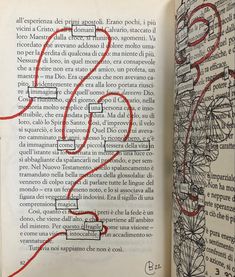 an open book with red writing on the pages and a hand drawn question mark in it