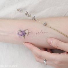 a woman's arm with flowers on it and the word sparkle written in cursive writing