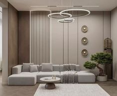 a modern living room with grey couches and round chandeliers hanging from the ceiling