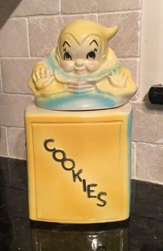 a ceramic cookie jar with an image of a cat on it