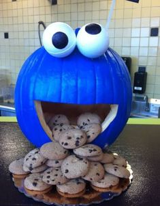 an assortment of desserts including cookies, oranges and cupcakes with eyes on them