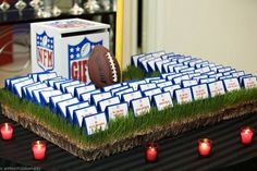 a football themed table with candles and place cards