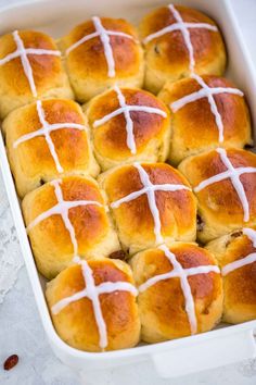 hot cross buns with white icing in a casserole dish